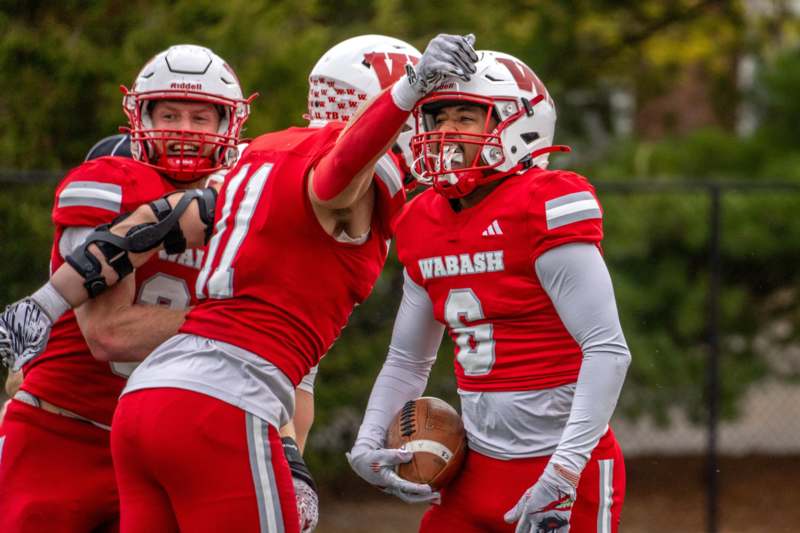 a group of football players in red uniforms
