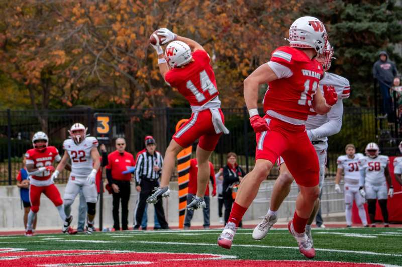 a group of football players in red uniforms