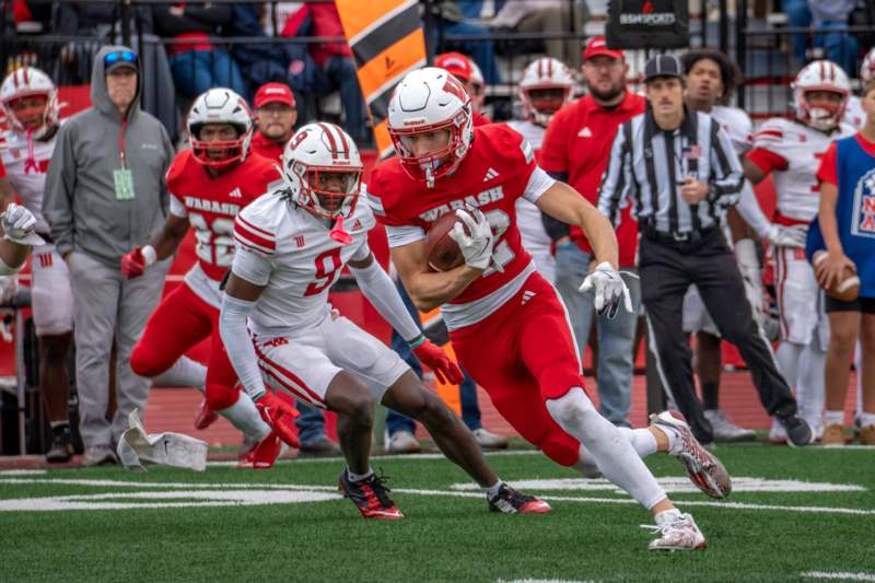 a football player running with a football in the back