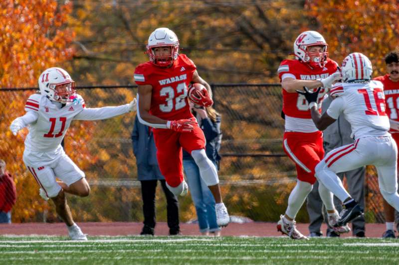 a group of football players running on a field