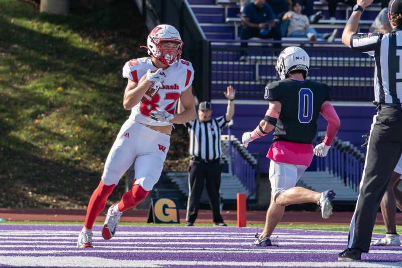a football player running with another football player in the background