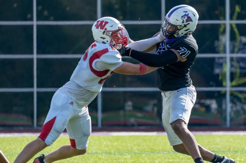 two football players fighting for the ball