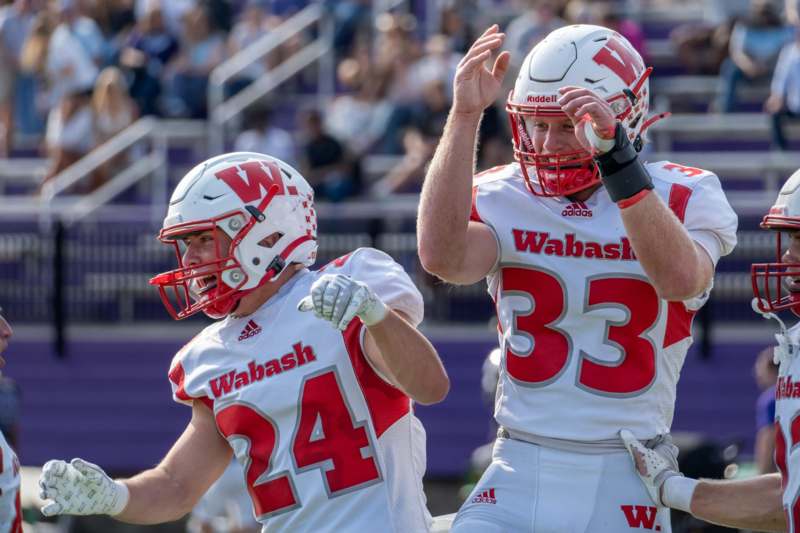 two football players in white and red uniforms