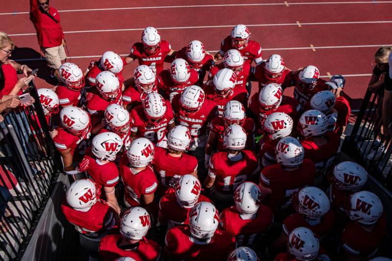 a group of football players in red uniforms