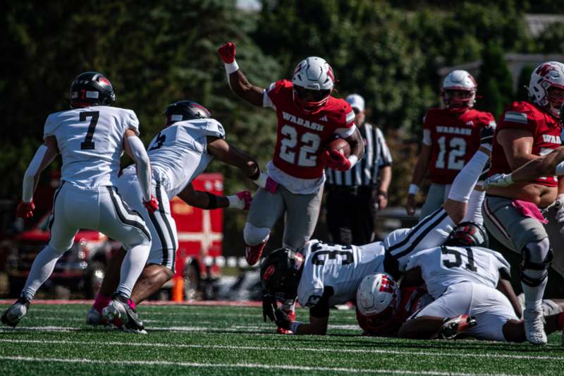 a football player running with his arms raised