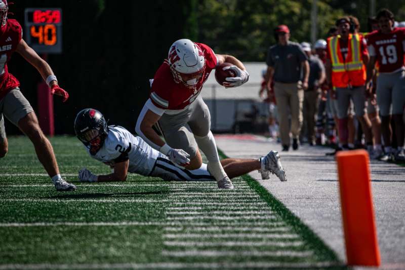 a football player diving for a ball