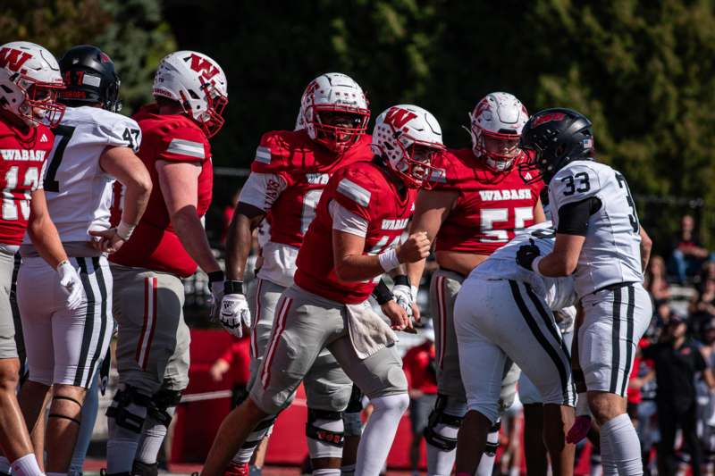 a group of football players in red and white uniforms
