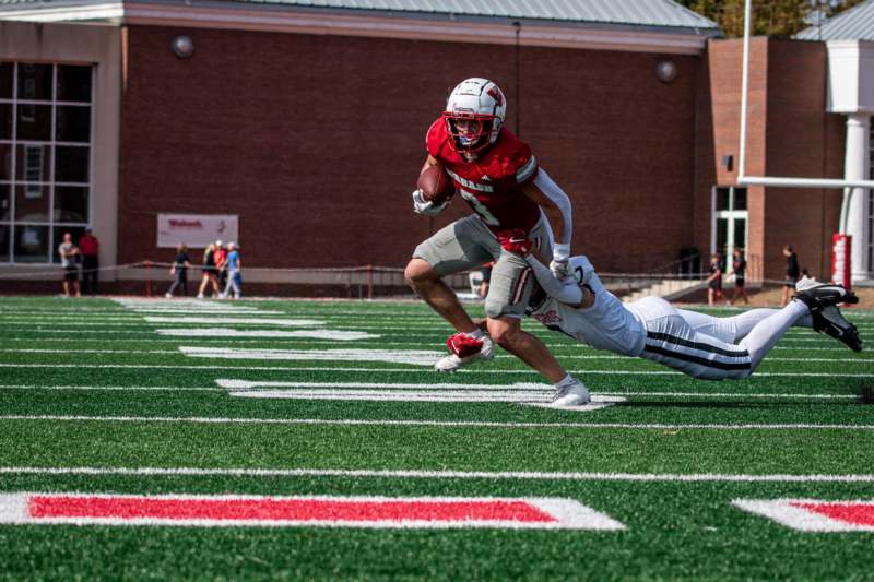 a football player diving for a ball