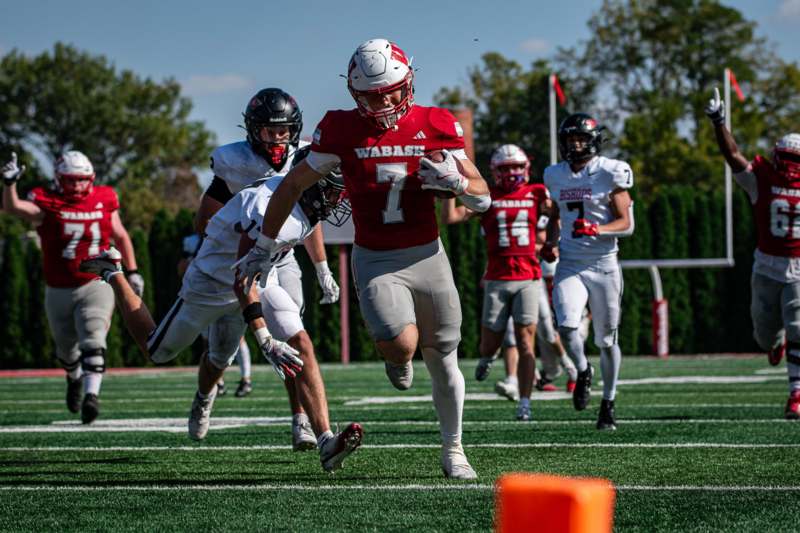 a group of football players running on a field