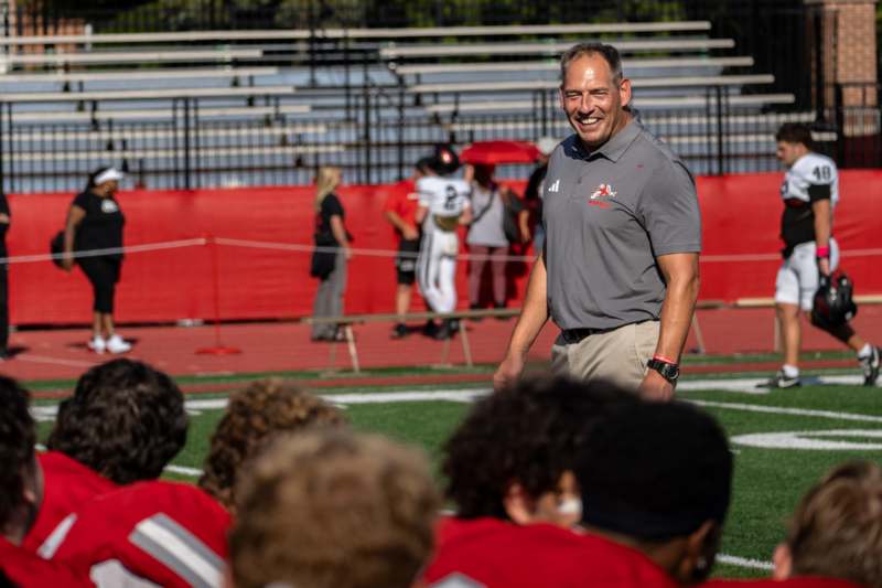 a man standing on a field with a group of people watching