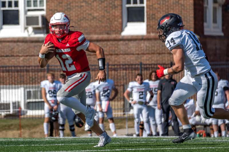 a football player running with another football player in the background