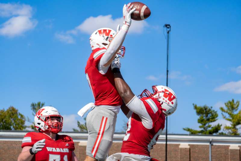a group of football players in red uniforms