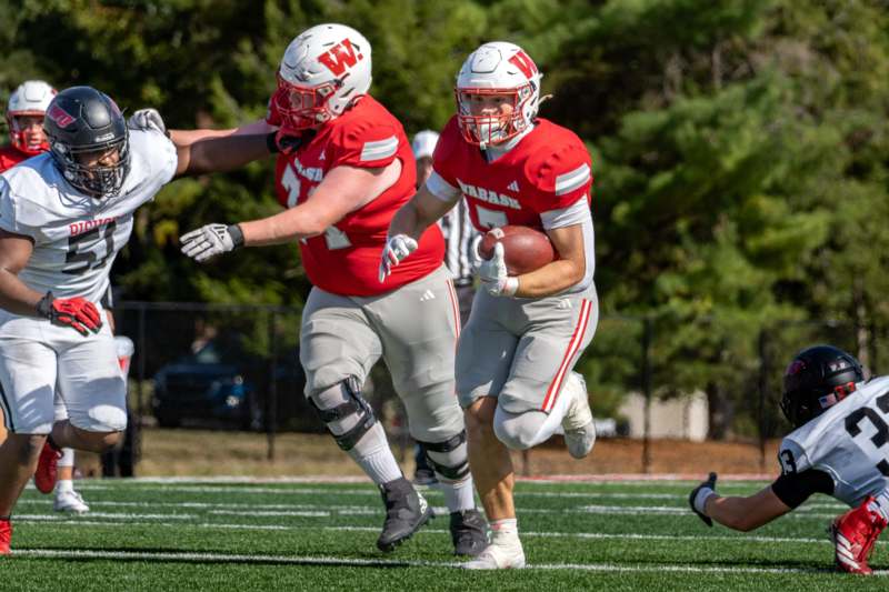 a group of football players running on a field