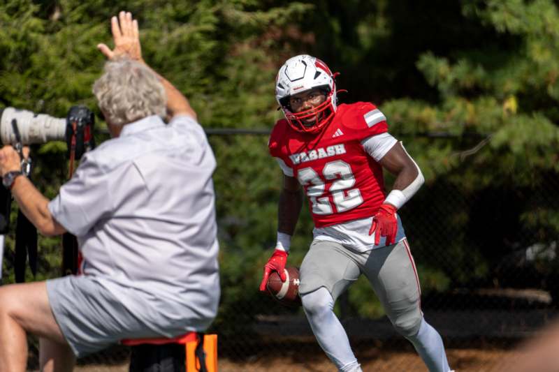 a football player in a red uniform with a football in his hand