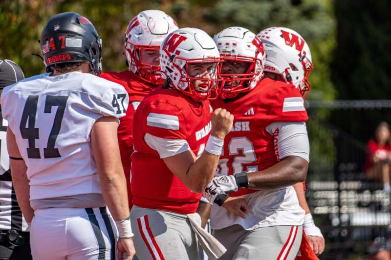 a group of football players in red and white uniforms
