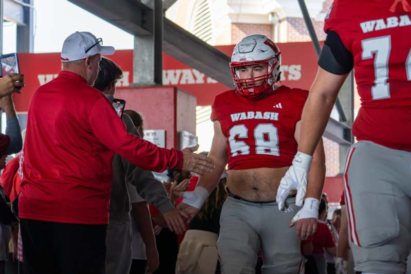 a football player shaking hands with other players