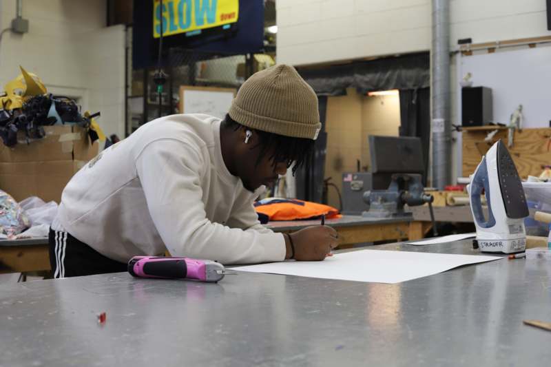 a man writing on a paper