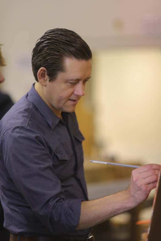 Classroom: ART 228 with Professor Damon Mohl - a man painting on a canvas