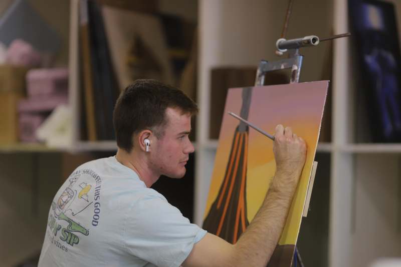 a man painting on an easel