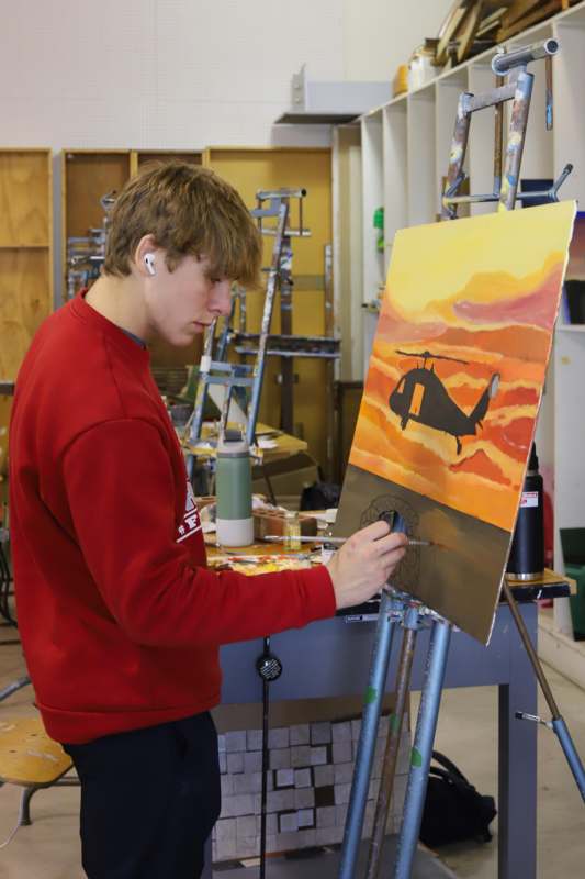 a man painting a picture