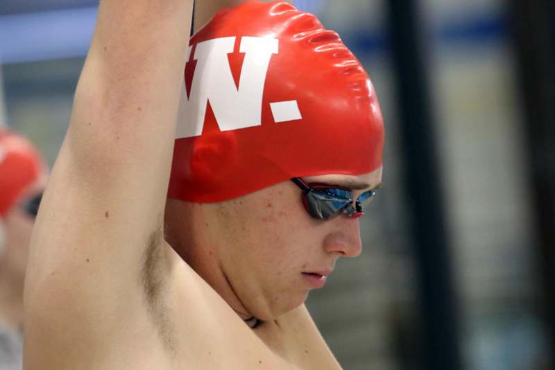 a man wearing a swim cap and goggles