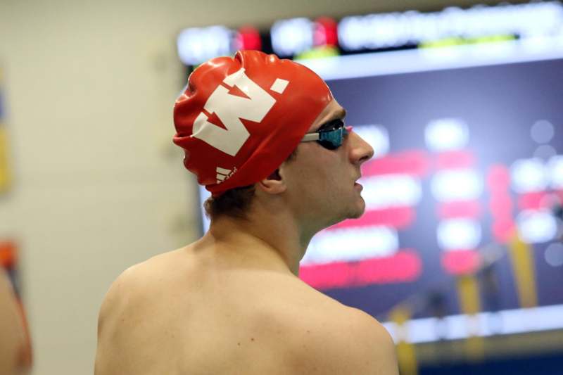 a man wearing a swim cap and goggles
