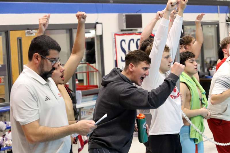 a group of people holding their hands up