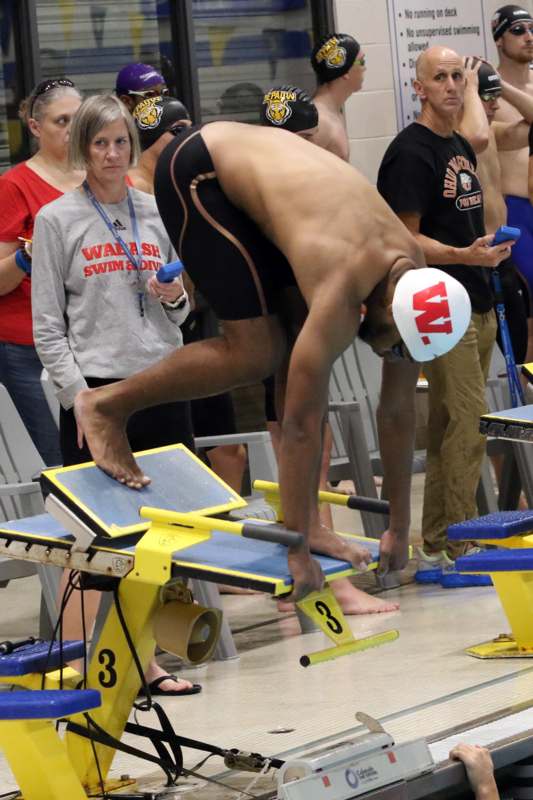 a man in a swim suit jumping on a platform