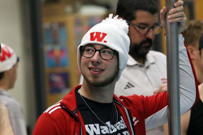 a man wearing glasses and a white beanie