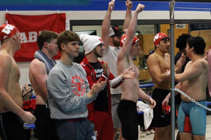 a group of men standing in a pool