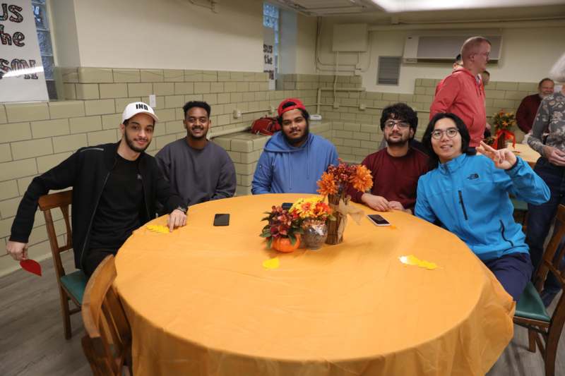 a group of people sitting at a round table