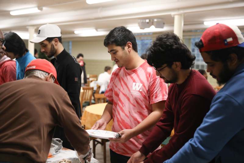 a group of people standing around a table
