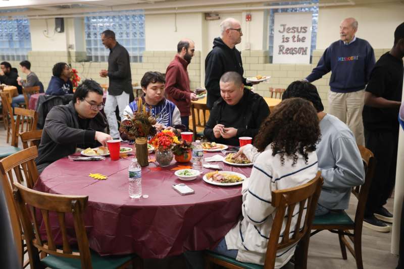 a group of people sitting around a table eating food