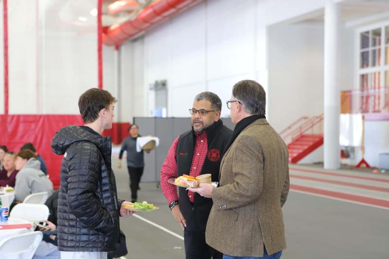 a group of men standing in a gym