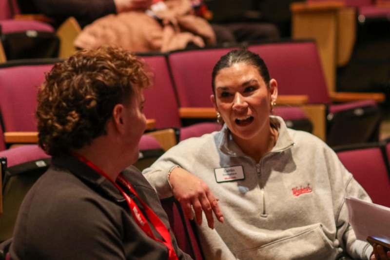 a woman talking to a man