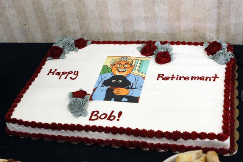 a cake with a picture of a man and a cat