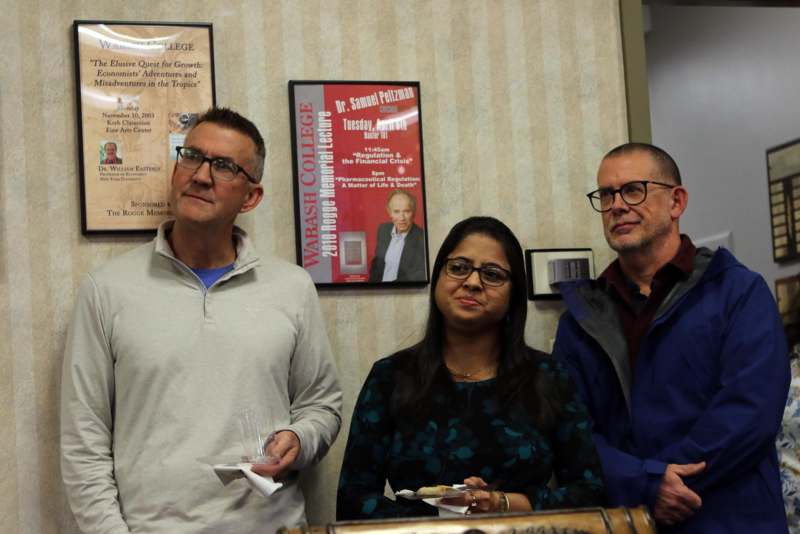 a group of people standing in front of a wall
