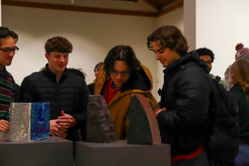 a group of people looking at a sculpture