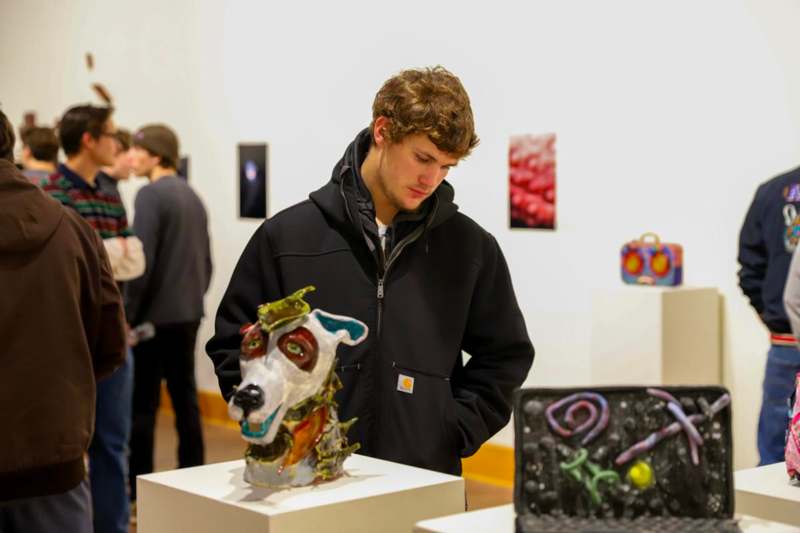 a man looking at a sculpture
