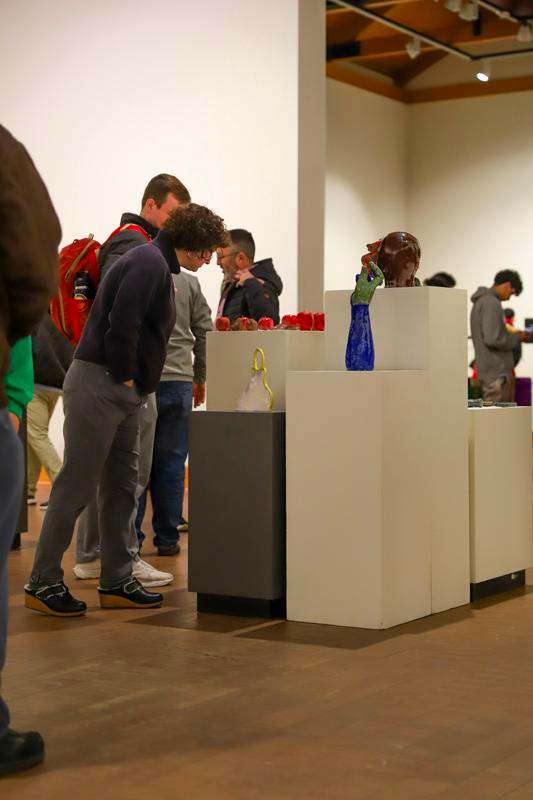 a group of people standing in a room with a group of people