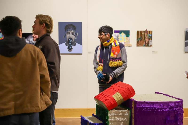 a group of men standing in a room with pinatas