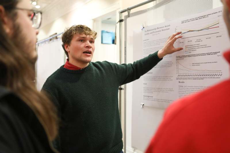 a man pointing at a white board