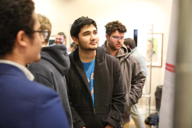 a man standing in a room with other people