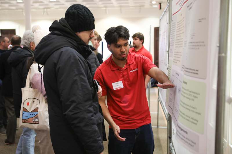 a man looking at a poster