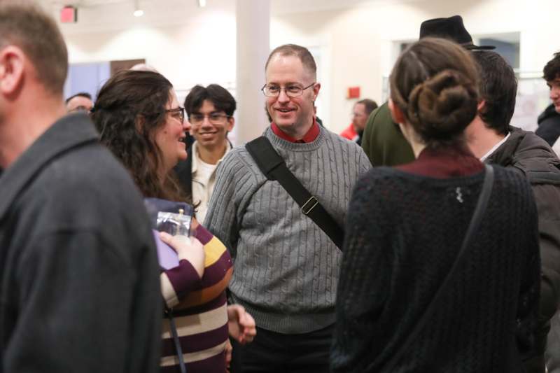 a group of people standing around each other