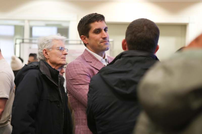 a man standing in a line with other people