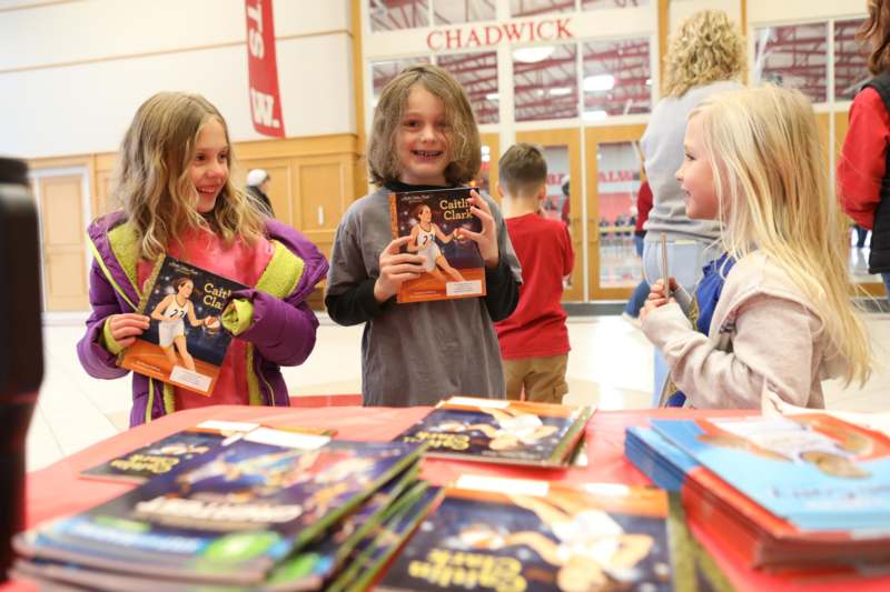 a group of children holding books