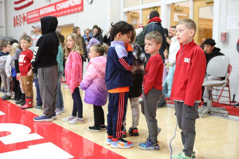 a group of children standing in a line