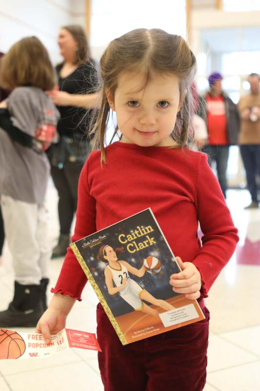 a girl holding a book