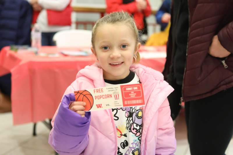 a girl holding a ticket